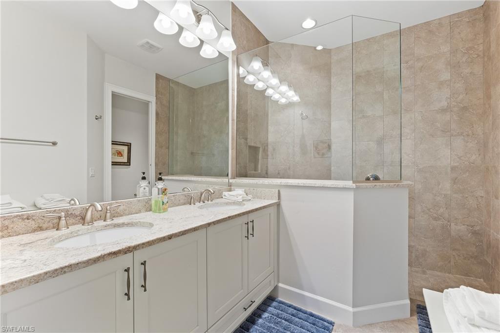 6939 Cay Court Naples, FL 34113 - Photo 11 of 30 a bathroom with a double vanity sink mirror and vanity