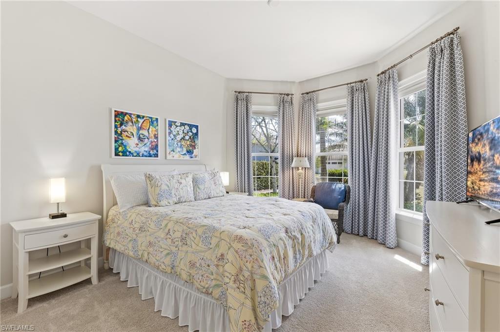 6939 Cay Court Naples, FL 34113 - Photo 12 of 30 a bedroom with a bed and a large window
