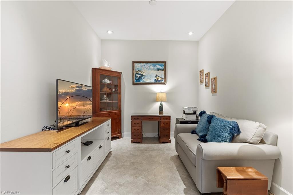 6939 Cay Court Naples, FL 34113 - Photo 15 of 30 a living room with furniture and a flat screen tv