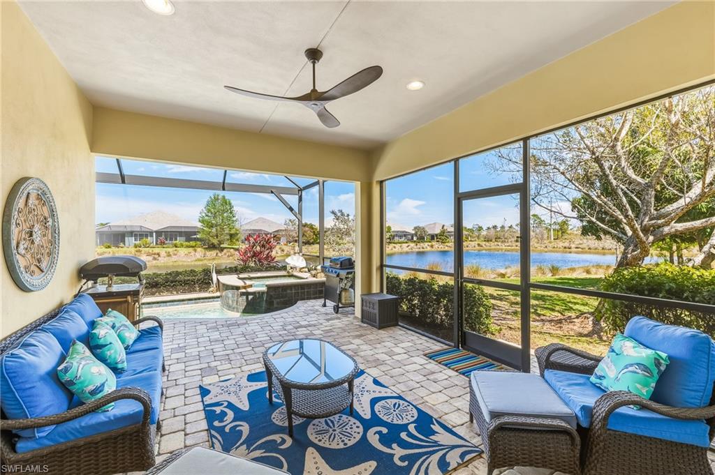 6939 Cay Court Naples, FL 34113 - Photo 18 of 30 a living room with furniture and a floor to ceiling window