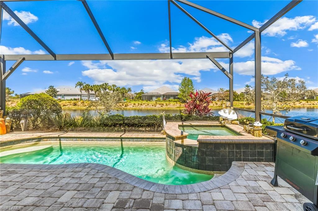 6939 Cay Court Naples, FL 34113 - Photo 2 of 30 a view of a swimming pool with a patio