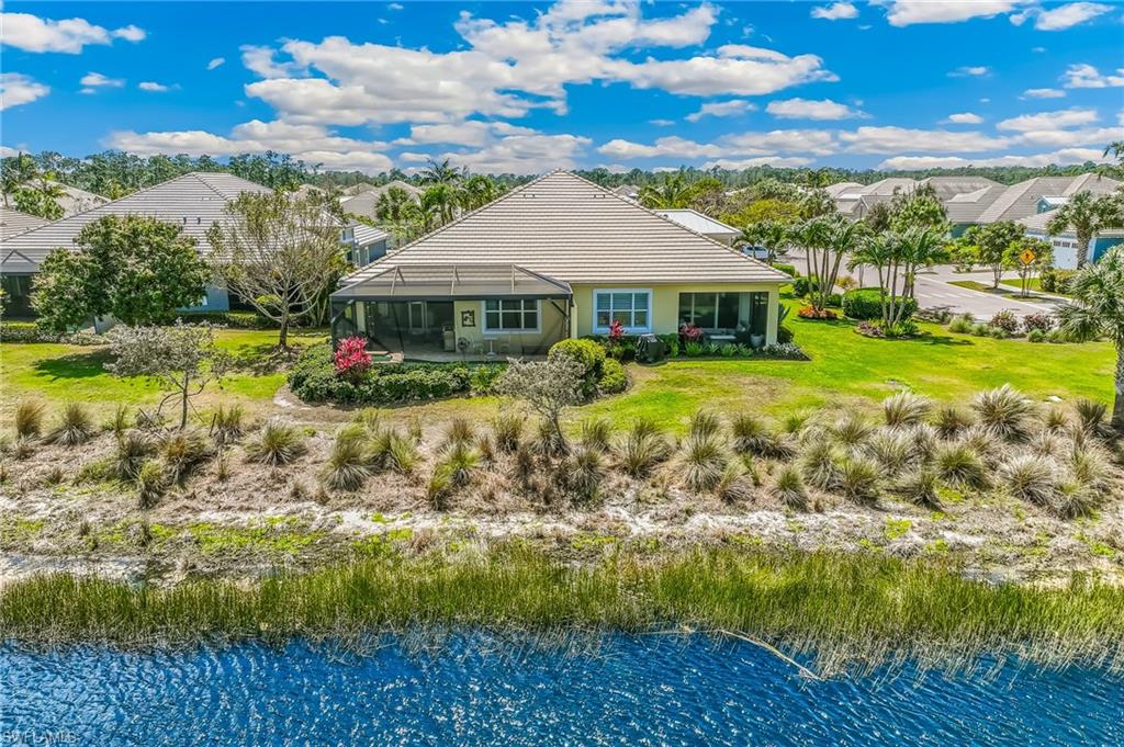 6939 Cay Court Naples, FL 34113 - Photo 24 of 30 a front view of house with yard and green space