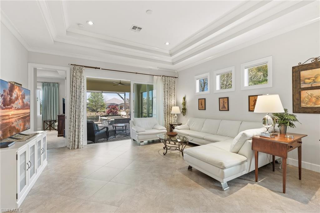 6939 Cay Court Naples, FL 34113 - Photo 3 of 30 a living room with furniture and a flat screen tv