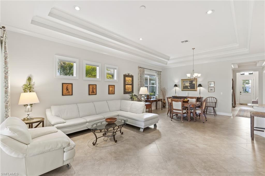6939 Cay Court Naples, FL 34113 - Photo 4 of 30 a living room with furniture and a chandelier