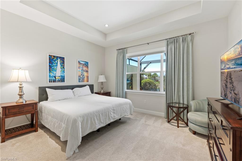 6939 Cay Court Naples, FL 34113 - Photo 10 of 30 a bedroom with a bed and a dresser next to a window