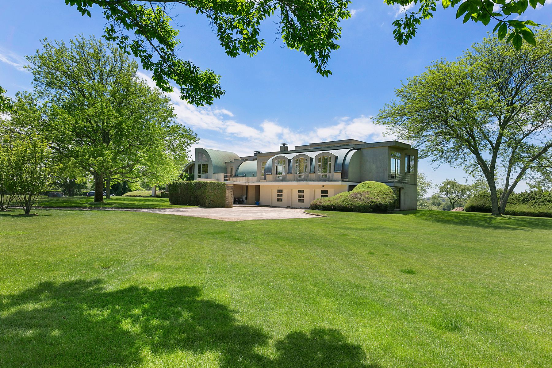 9 Morgan Hill Way Bridgehampton, NY 11932 - Photo 12 of 18 a front view of a house with a yard and trees