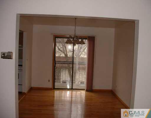 5705 Hana Road Edison, NJ 08817 - Photo 3 of 8 an empty room with wooden floor and windows