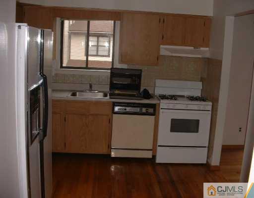 5705 Hana Road Edison, NJ 08817 - Photo 4 of 8 a kitchen with a stove and a refrigerator