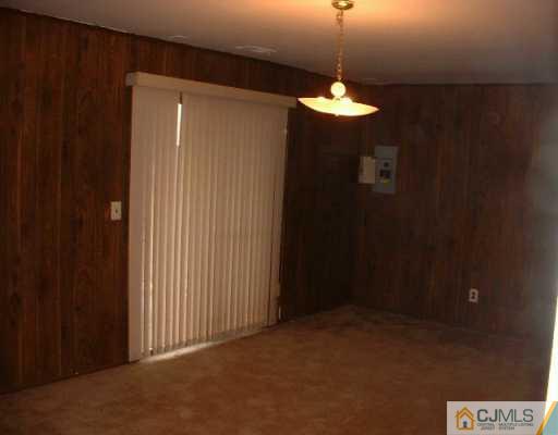 5705 Hana Road Edison, NJ 08817 - Photo 5 of 8 a view of a hallway with a chandelier