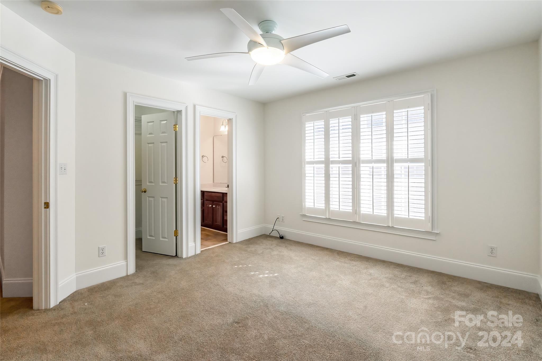 738 Portpatrick Place Fort Mill, SC 29708 - Photo 11 of 27 an empty room with chandelier fan and windows
