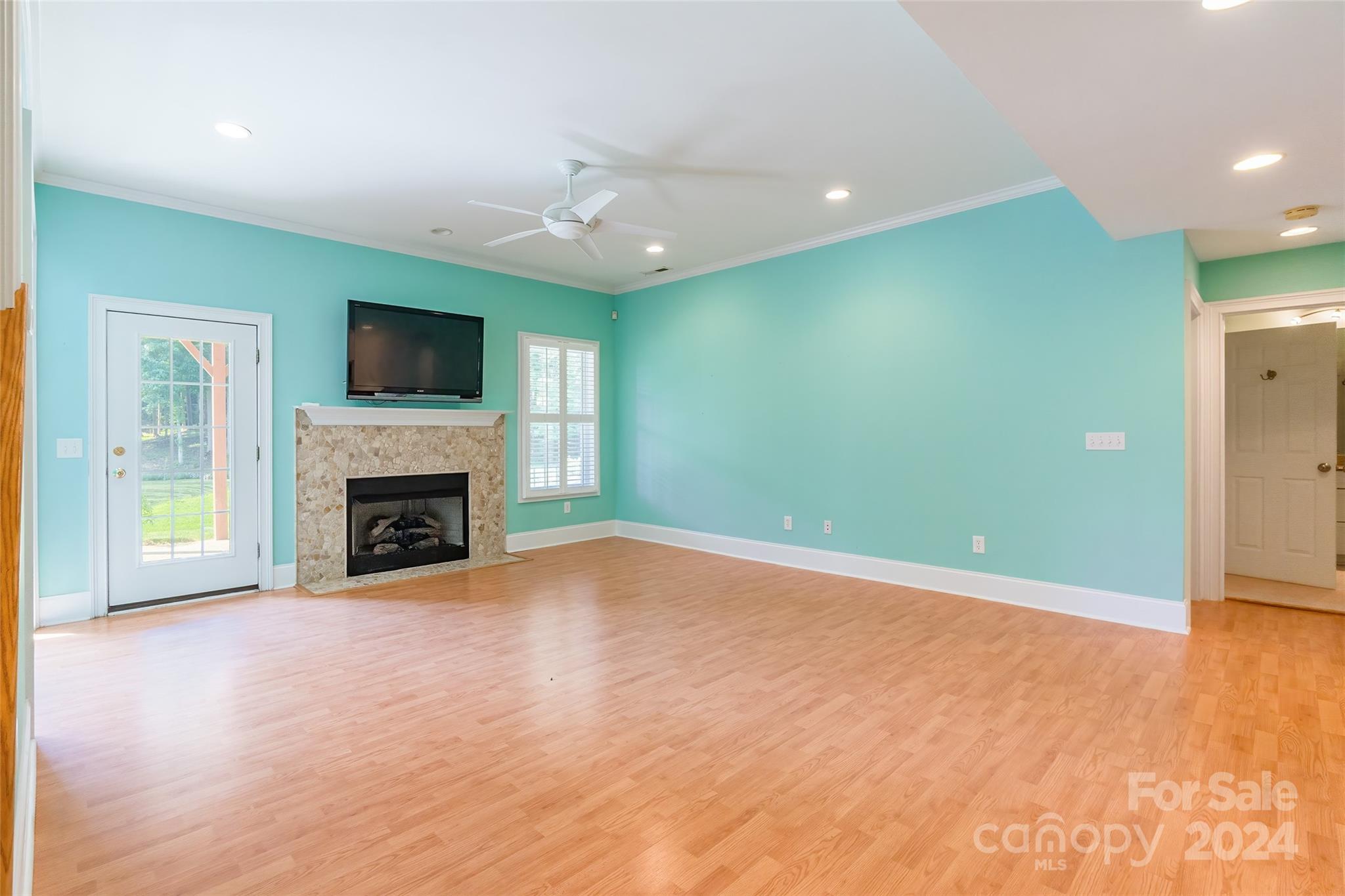 738 Portpatrick Place Fort Mill, SC 29708 - Photo 15 of 27 a view of empty room with a fireplace and a flat screen tv