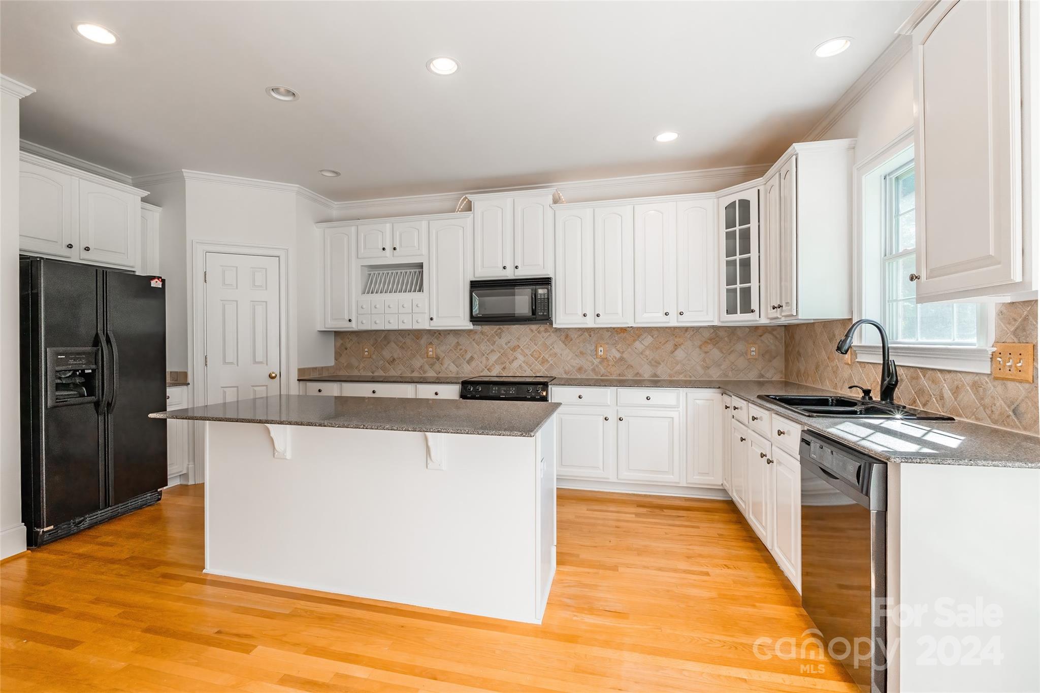 738 Portpatrick Place Fort Mill, SC 29708 - Photo 7 of 27 a large kitchen with stainless steel appliances granite countertop a stove a sink and a refrigerator