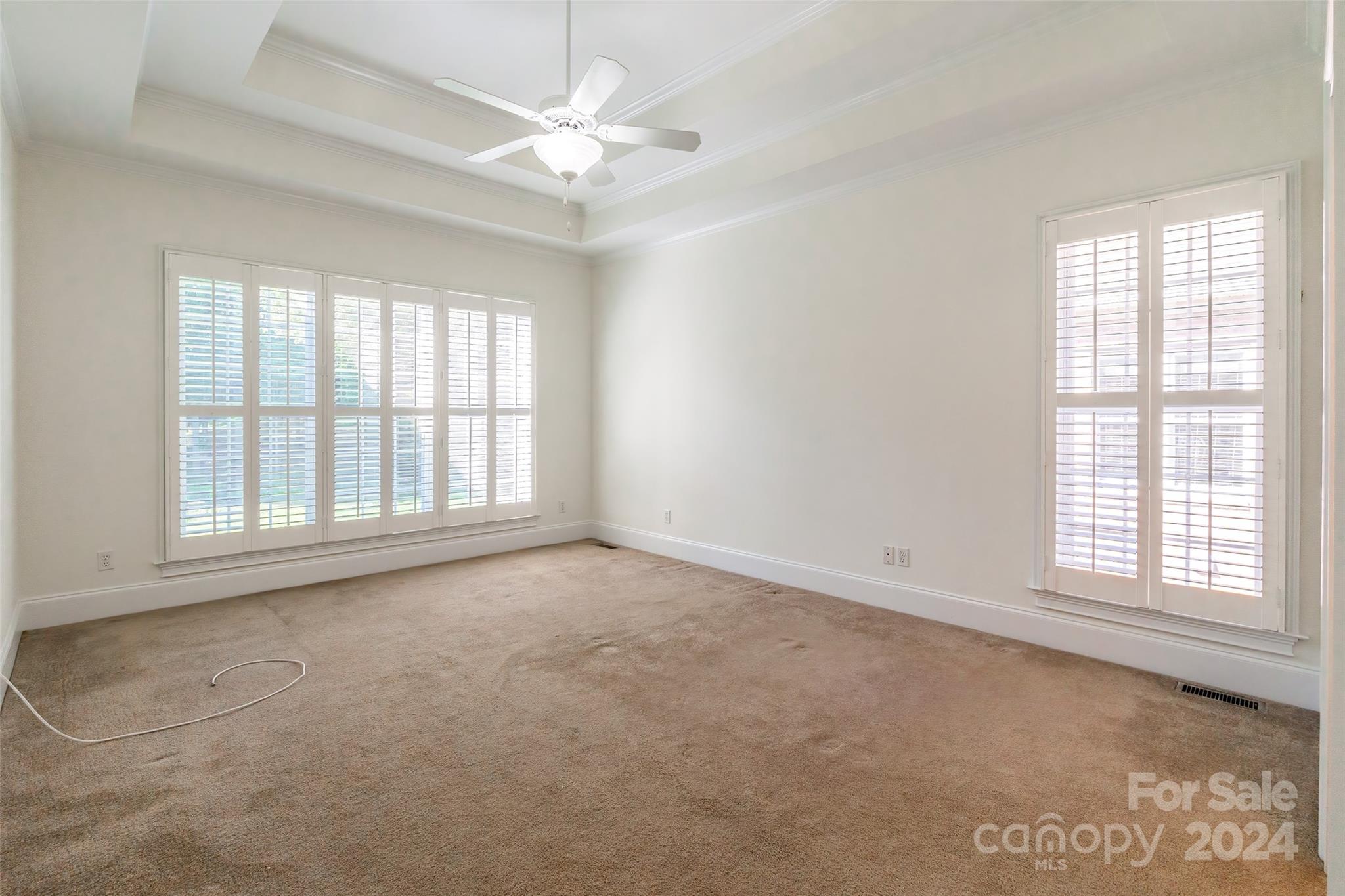 738 Portpatrick Place Fort Mill, SC 29708 - Photo 8 of 27 an empty room with chandelier fan and windows