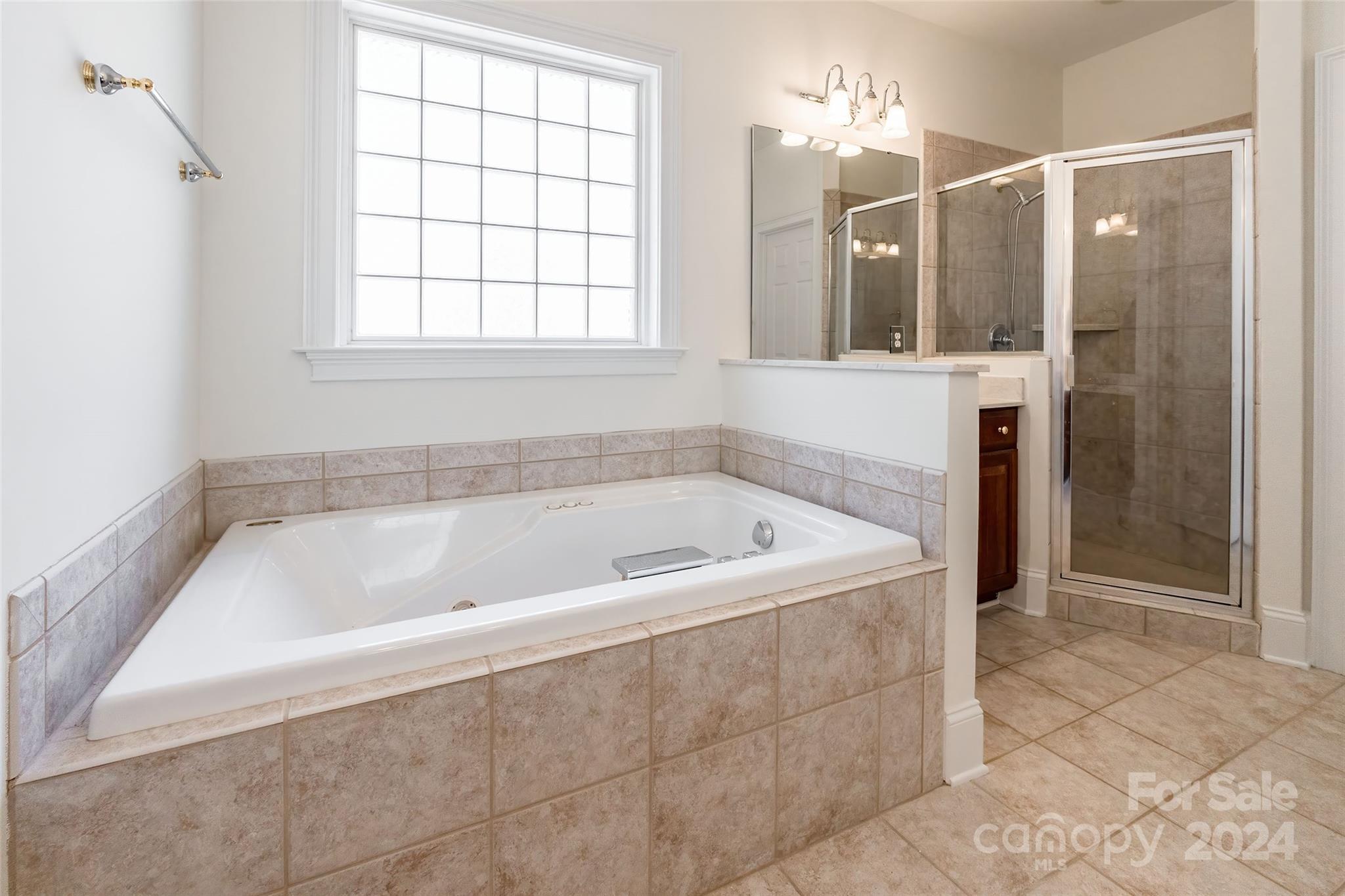 738 Portpatrick Place Fort Mill, SC 29708 - Photo 9 of 27 a bathroom with a bathtub and a shower