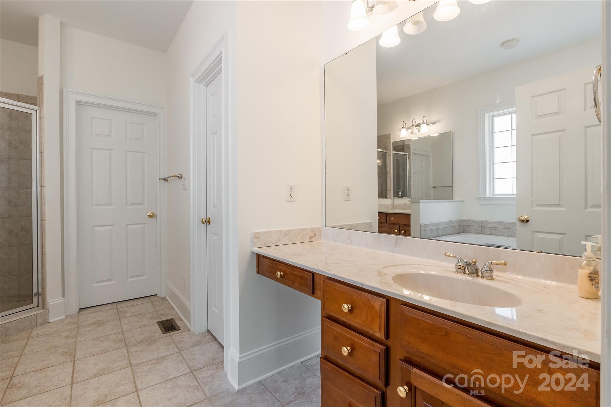 738 Portpatrick Place Fort Mill, SC 29708 - Photo 10 of 27 a bathroom with a sink and a mirror