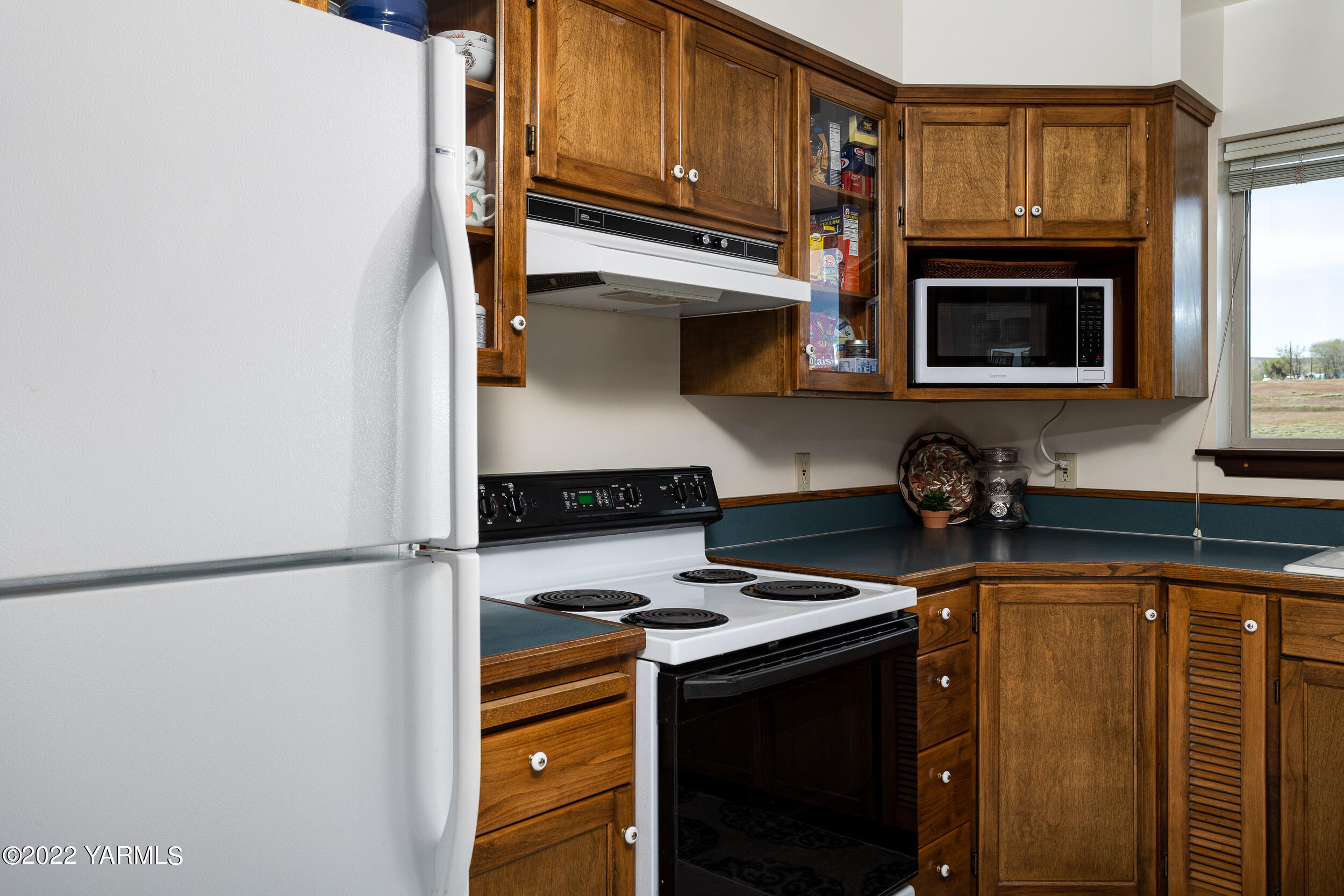 2450 Cook Road Yakima, WA 98908 - Photo 12 of 52 a kitchen with stainless steel appliances granite countertop a stove and a microwave