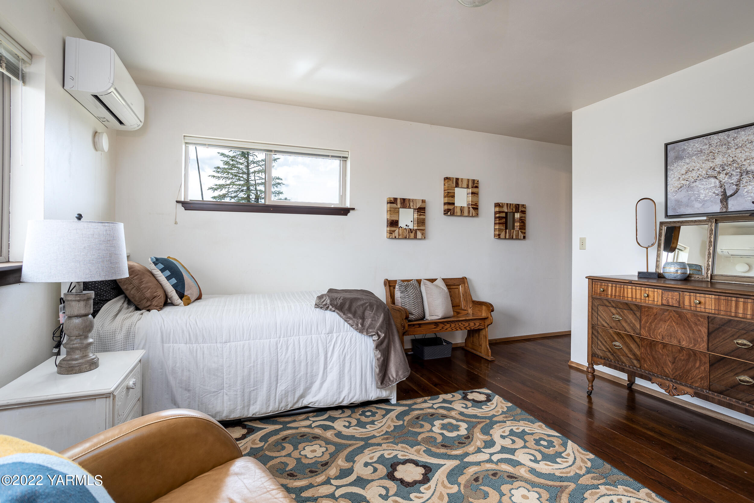 2450 Cook Road Yakima, WA 98908 - Photo 18 of 52 a bedroom with a bed and wooden floor