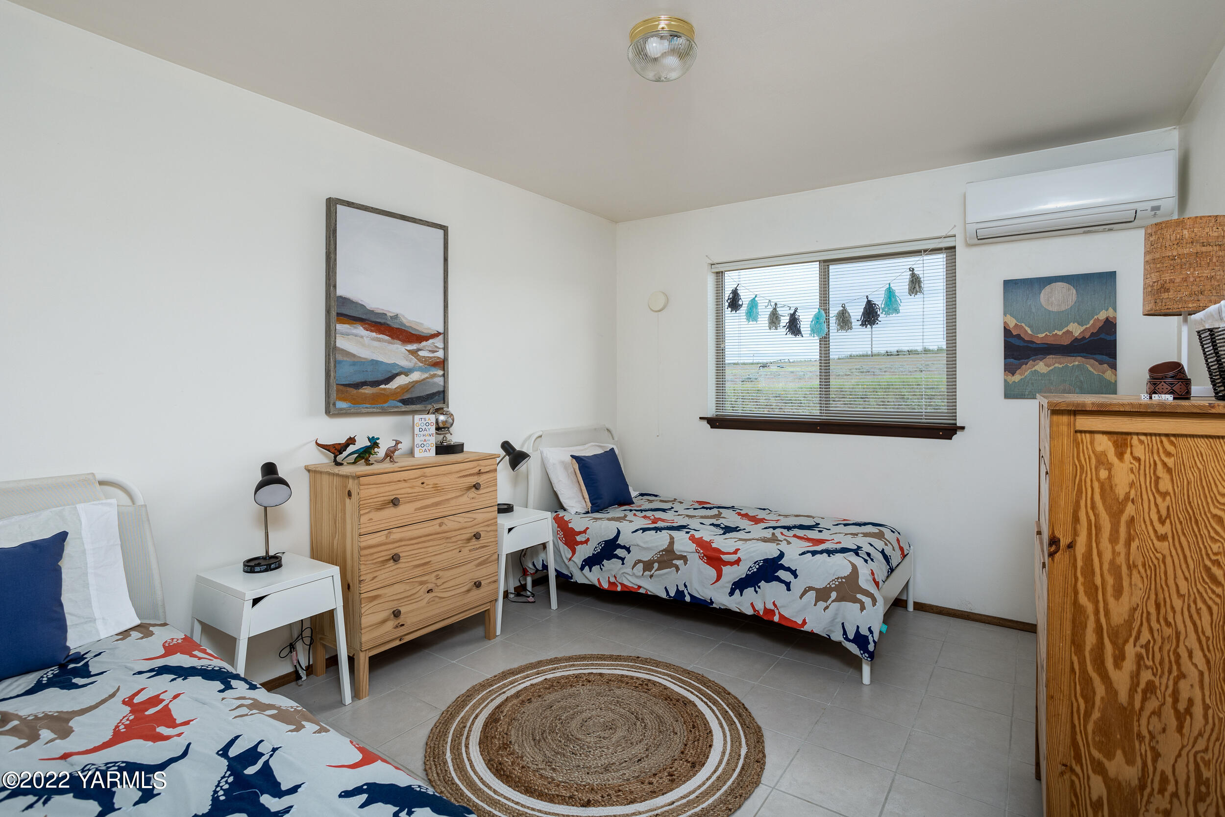 2450 Cook Road Yakima, WA 98908 - Photo 21 of 52 a bedroom with a bed and wooden floor