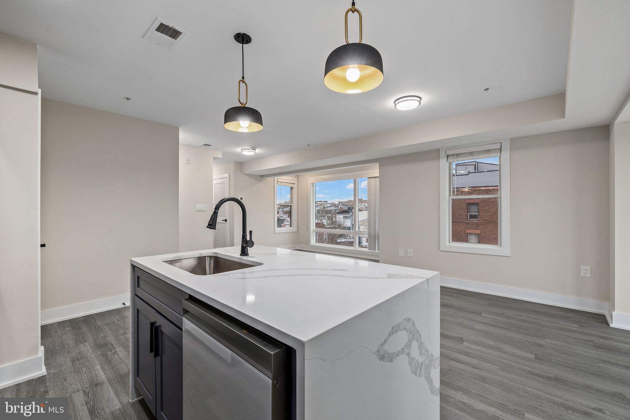 3517 14th Street Northwest, Unit 301 Washington, DC 20010 - Photo 12 of 27 a kitchen with a sink and a stove