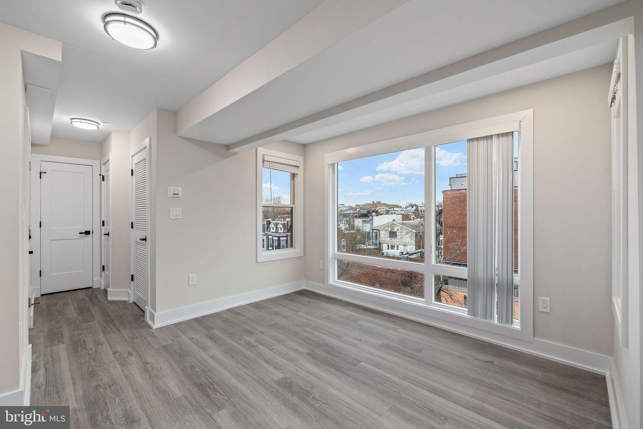3517 14th Street Northwest, Unit 301 Washington, DC 20010 - Photo 14 of 27 an empty room with wooden floor and windows