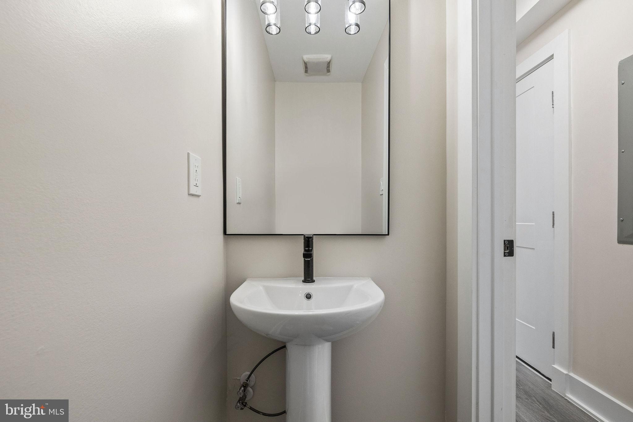 3517 14th Street Northwest, Unit 301 Washington, DC 20010 - Photo 16 of 27 a bathroom with a sink and a mirror