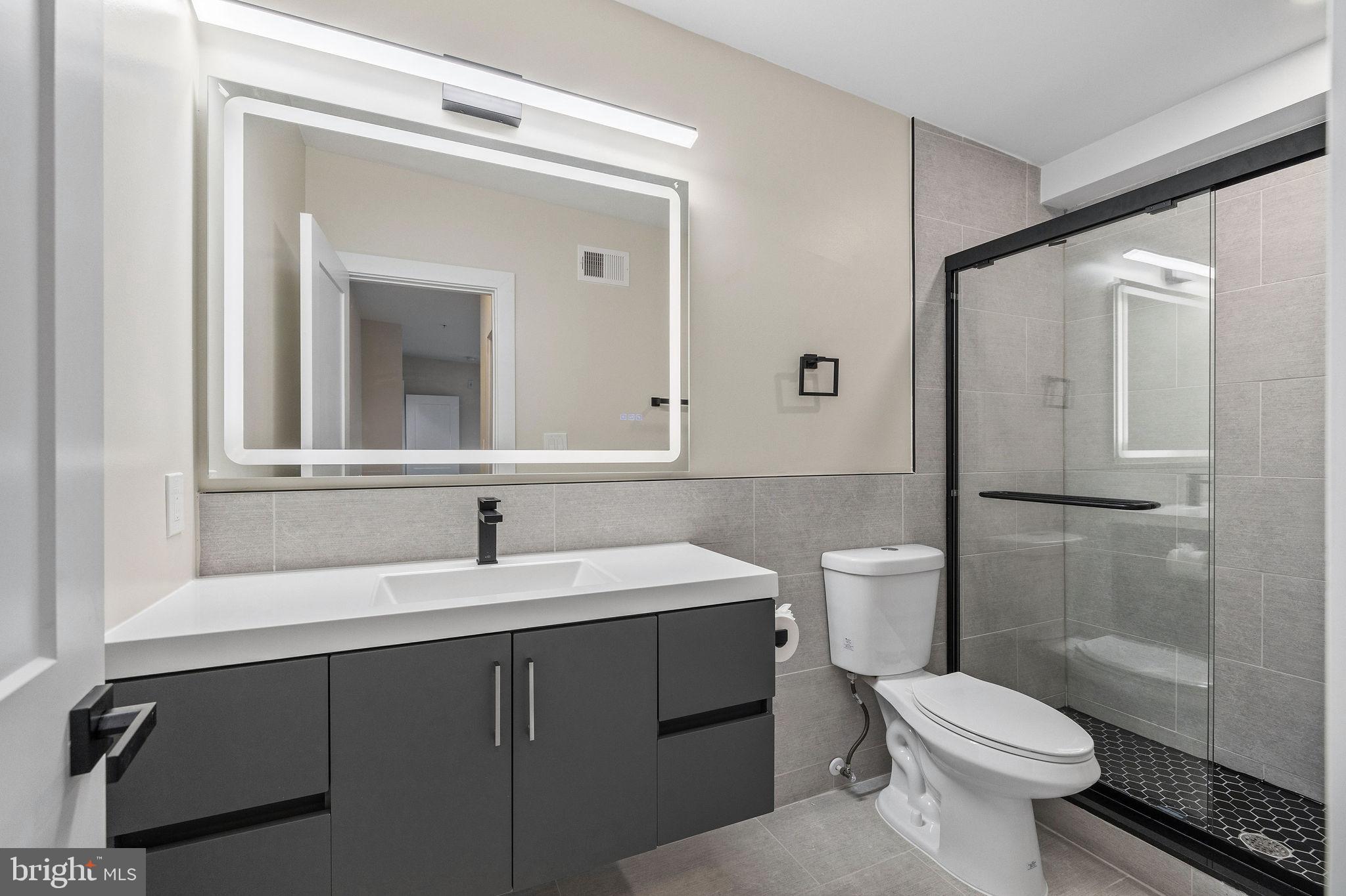 3517 14th Street Northwest, Unit 301 Washington, DC 20010 - Photo 21 of 27 a bathroom with a sink toilet and shower