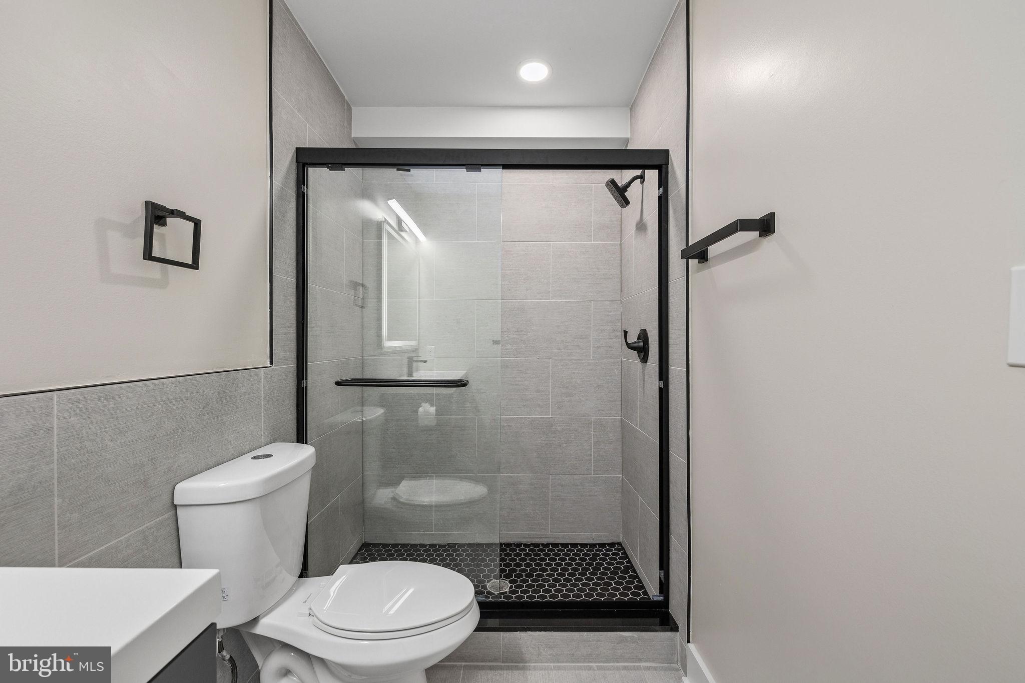 3517 14th Street Northwest, Unit 301 Washington, DC 20010 - Photo 22 of 27 a white toilet sitting next to a bathroom sink