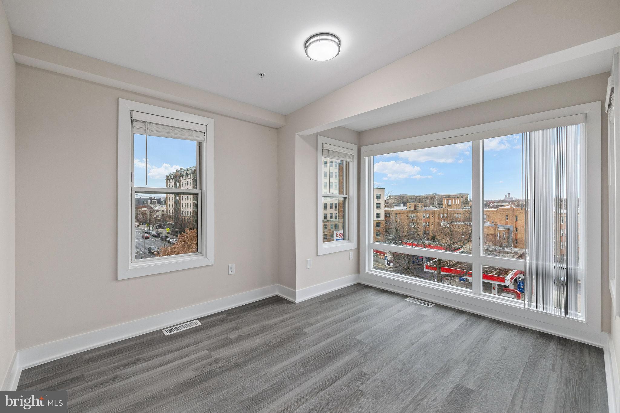 3517 14th Street Northwest, Unit 301 Washington, DC 20010 - Photo 23 of 27 an empty room with wooden floor and windows