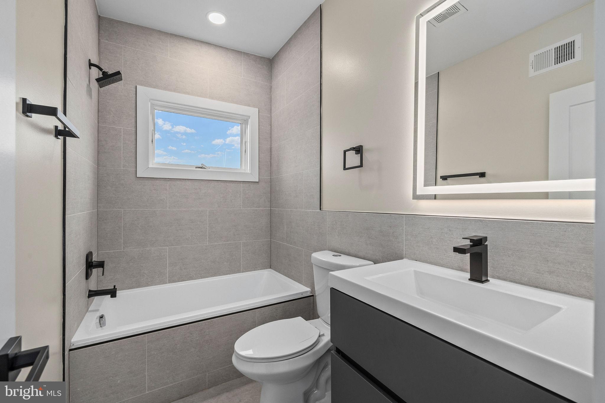 3517 14th Street Northwest, Unit 301 Washington, DC 20010 - Photo 26 of 27 a bathroom with a sink a toilet and shower