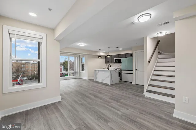 a kitchen with a refrigerator and a stove top oven