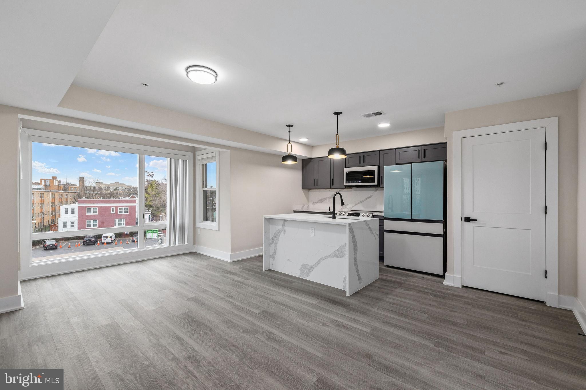 3517 14th Street Northwest, Unit 301 Washington, DC 20010 - Photo 8 of 27 a kitchen with a refrigerator and a stove top oven