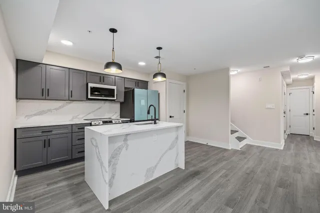 a kitchen with a sink and a stove