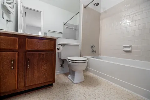 a bathroom with a toilet and a bathtub