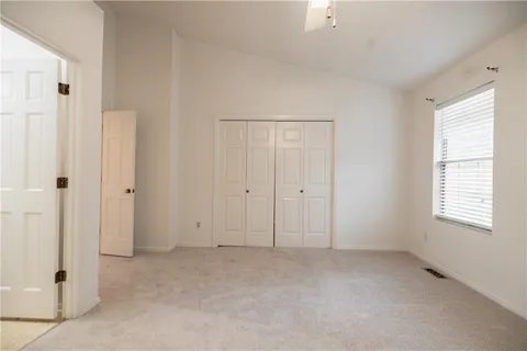 an empty room with windows and closet