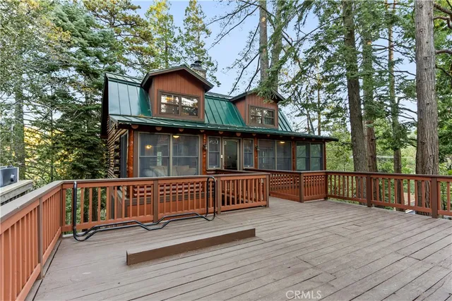 a view of house with deck and outdoor seating