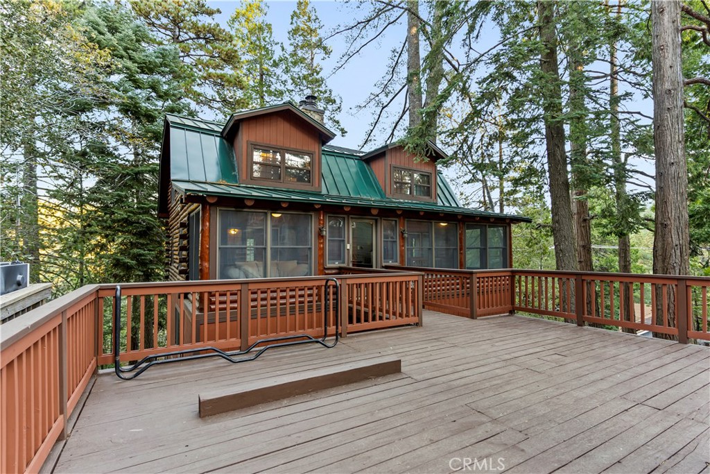 a view of house with deck and outdoor seating