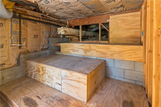 a front view of a house with a tree