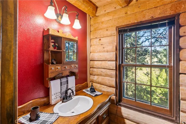 a bathroom with a toilet a sink and a window