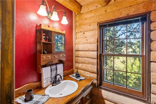 a bathroom with a toilet a sink and a window