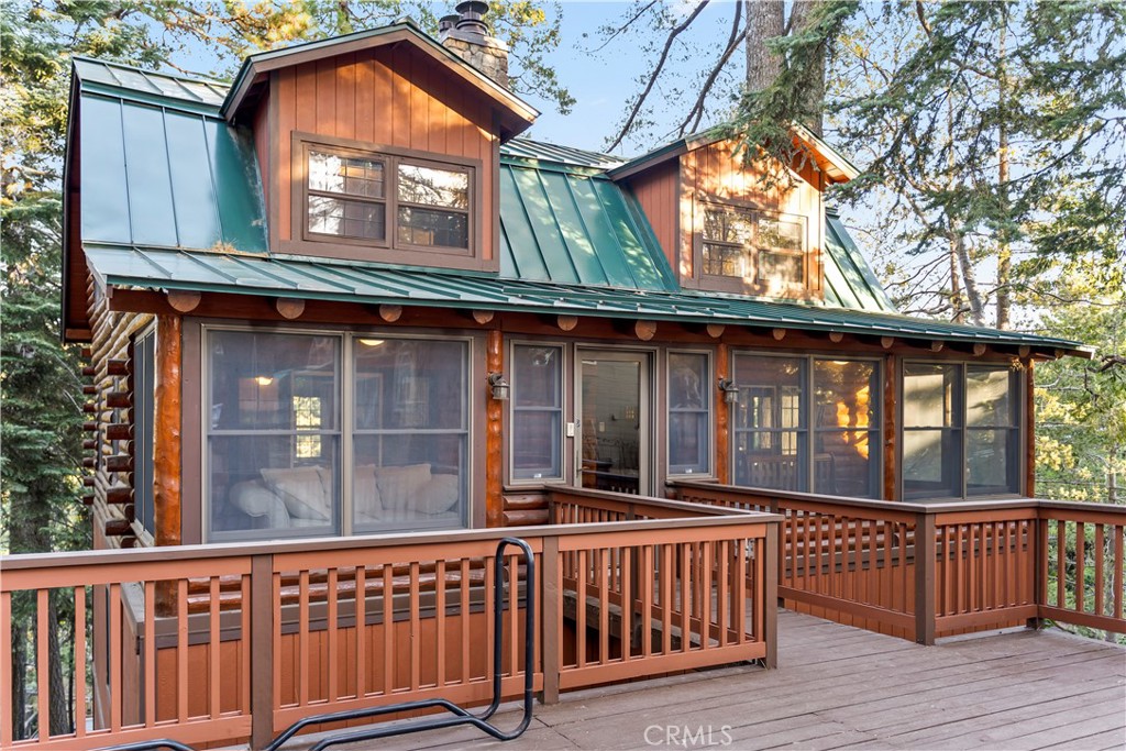 26638 Lake Forest Drive Twin Peaks, CA 92391 - Photo 3 of 72 a view of a brick house with large windows