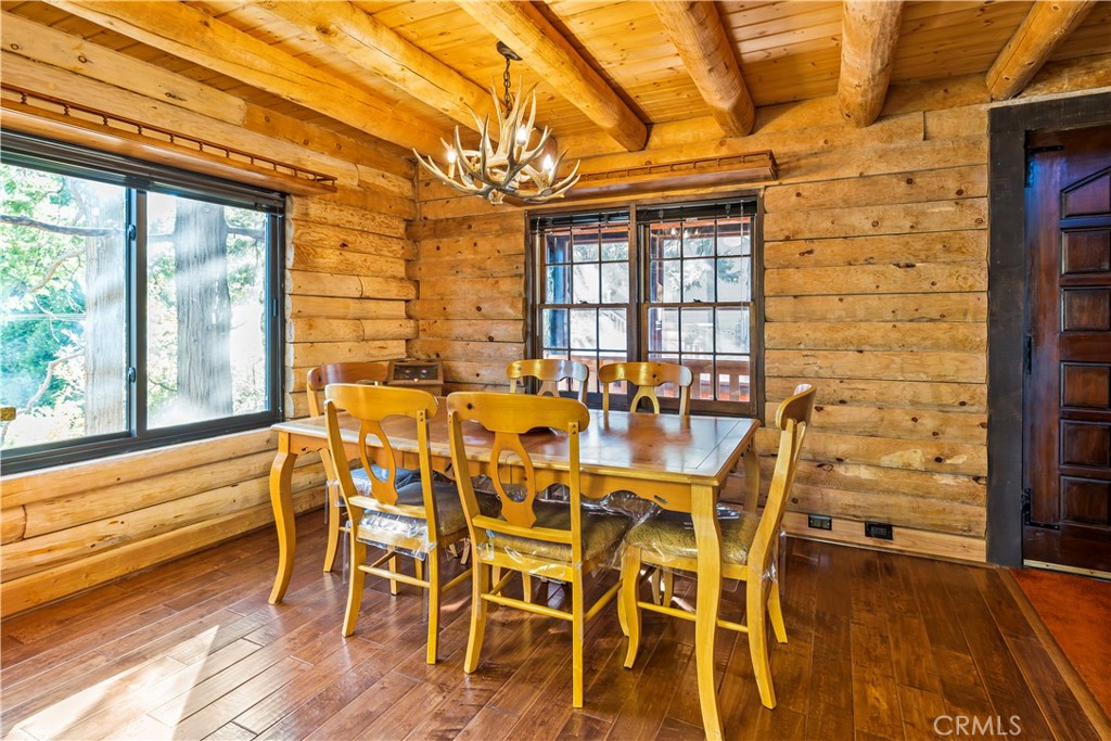 26638 Lake Forest Drive Twin Peaks, CA 92391 - Photo 31 of 72 a dining room with furniture a chandelier and wooden floor