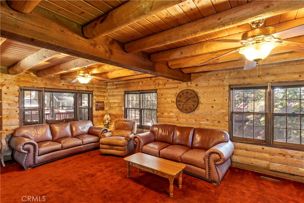 26638 Lake Forest Drive Twin Peaks, CA 92391 - Photo 6 of 72 a living room with furniture a ceiling fan and a next to a window