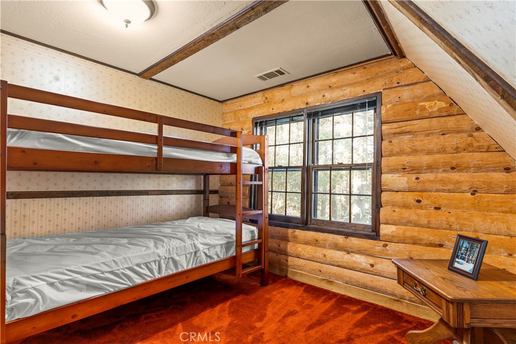 26638 Lake Forest Drive Twin Peaks, CA 92391 - Photo 61 of 72 a bedroom with a bed and a window