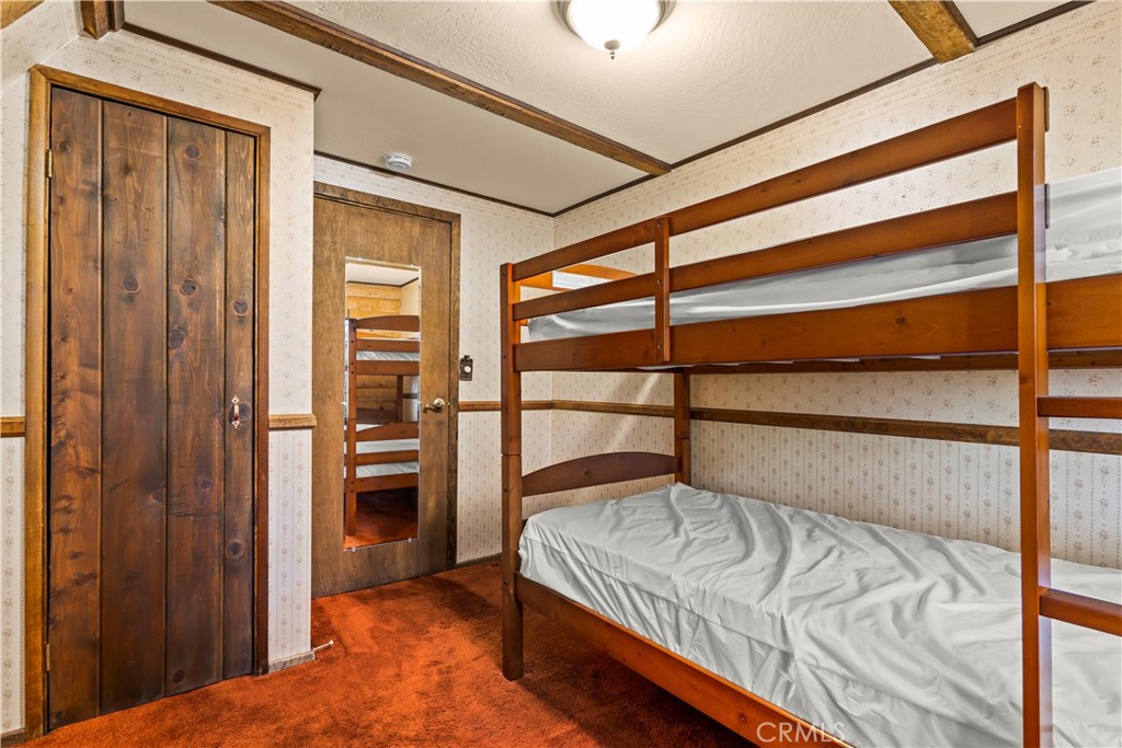 26638 Lake Forest Drive Twin Peaks, CA 92391 - Photo 62 of 72 a bedroom with a bed and a window