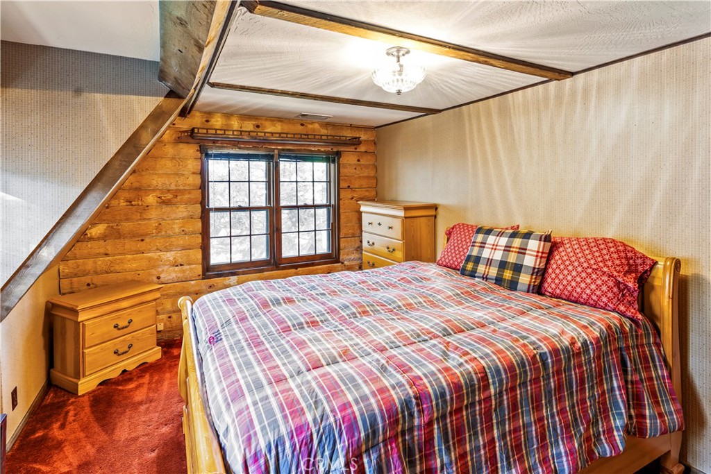 26638 Lake Forest Drive Twin Peaks, CA 92391 - Photo 63 of 72 a bed sitting in a bedroom next to a window