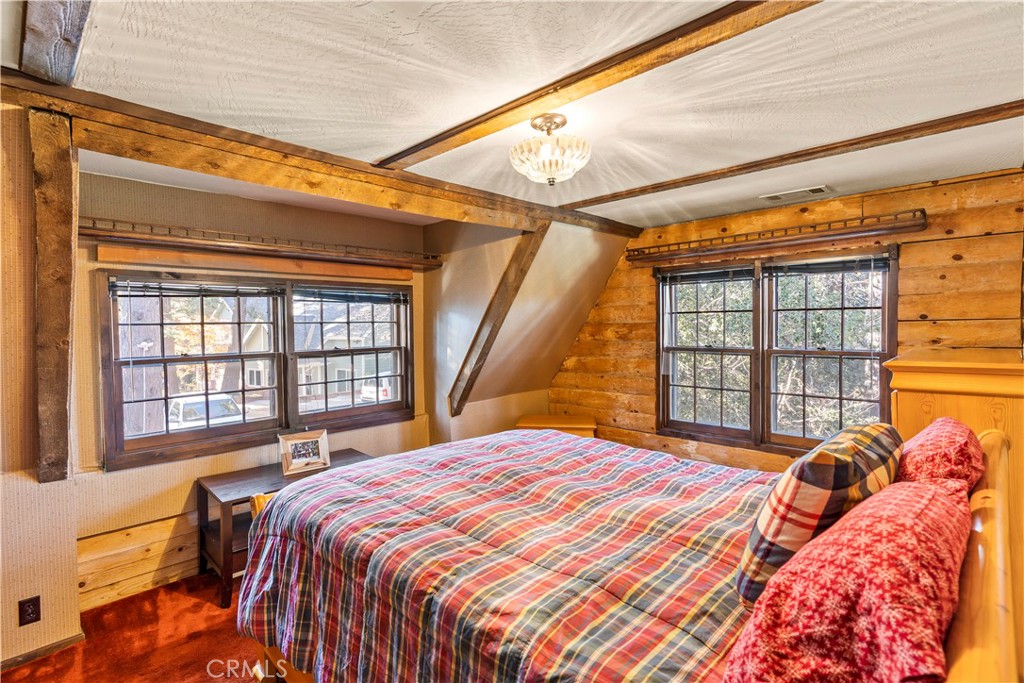 26638 Lake Forest Drive Twin Peaks, CA 92391 - Photo 64 of 72 a bedroom with a bed and a large window
