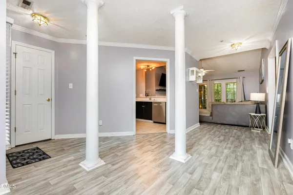 a living room with furniture and a wooden floor