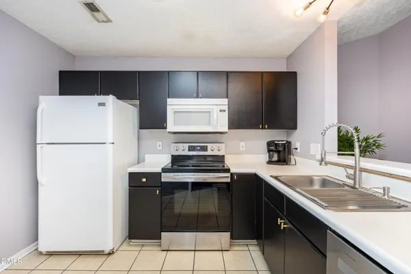 a kitchen with a sink stove and microwave