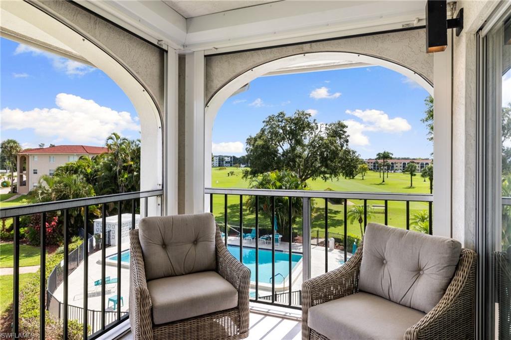 5 High Point Circle West, Unit 307 Naples, FL 34103 - Photo 22 of 31 Balcony featuring view of pool area and golf course view