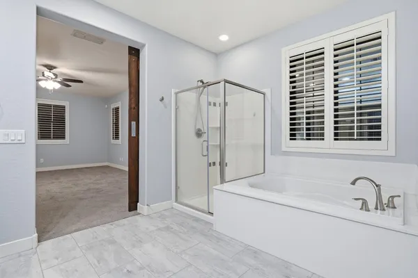 a bathroom with a bathtub and a shower